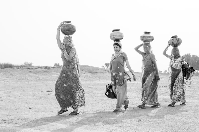 Women and Drinking Water Challenges - Bringing drinking water from a distant well in the scorching heat of the day in Bikaner district, Rajasthan